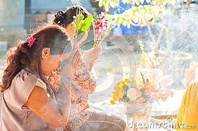 Buddhist pays respect to the Buddha image. Editorial Stock Photo